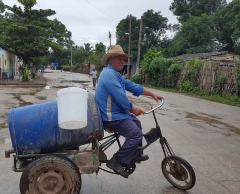 Man carrying jerry can of water