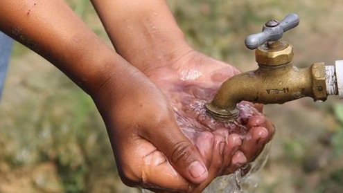 child collecting tap water